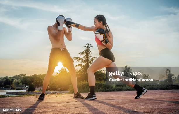 man and a woman practicing kick boxing - an evening dedicated to women of substance imagens e fotografias de stock