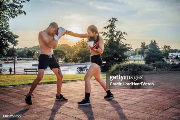 man and a woman practicing kick boxing - an evening dedicated to women of substance imagens e fotografias de stock