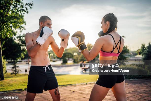 man and woman boxer on training outdoor - an evening dedicated to women of substance imagens e fotografias de stock