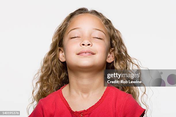 smiling girl (8-9) with eyes closed, studio shot - child eyes closed stock pictures, royalty-free photos & images