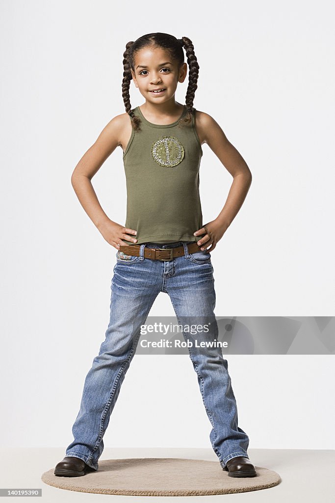 Studio portrait of smiling girl (8-9) with plaits