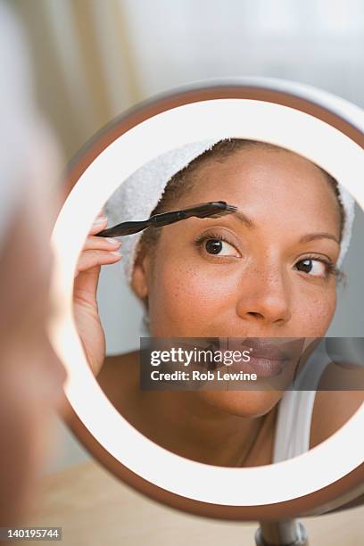 usa, california, los angeles, woman brushing eyebrow - woman beautiful brows beauty stock-fotos und bilder