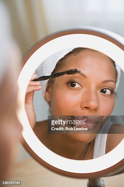 usa, california, los angeles, woman brushing eyebrow - eyebrow stock pictures, royalty-free photos & images