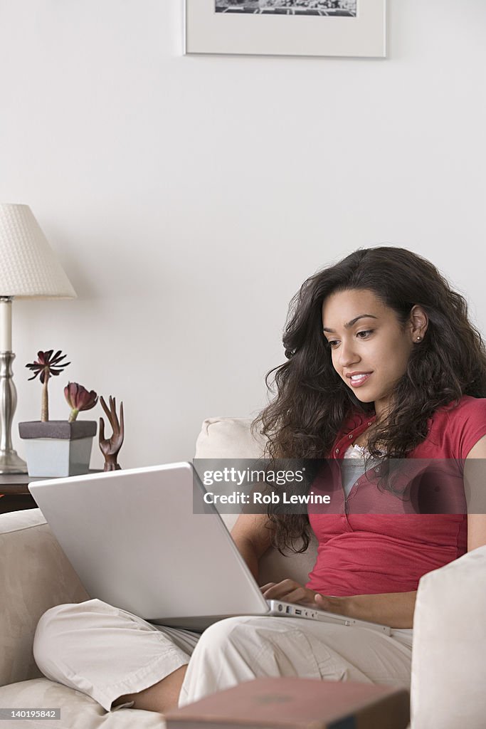 USA, California, Los Angeles, Young woman using laptop at home