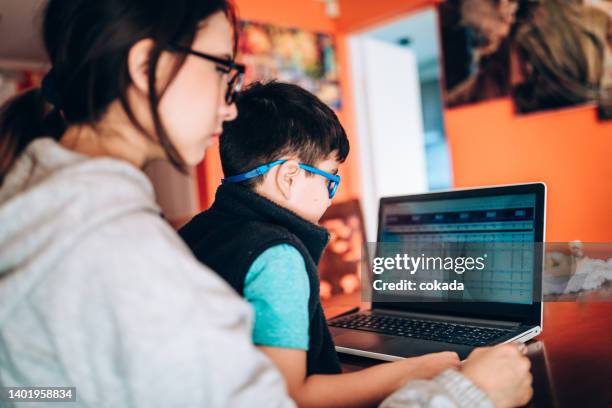 siblings learning finance - children looking graph stock pictures, royalty-free photos & images