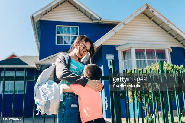 brother and sister hugging in front of their home - chilean ethnicity stock pictures, royalty-free photos & images