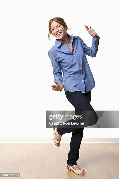 studio portrait of young woman dancing - dancing white background stock pictures, royalty-free photos & images