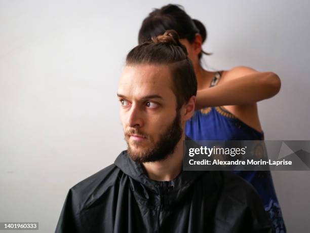 young white male with beard get a hair cut by a a young woman - cutting long hair stock pictures, royalty-free photos & images