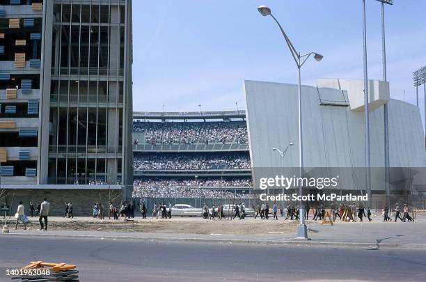 View from outside Shea Stadium of spectators walking towards the entrance on opening day, New York, New York, April 17, 1964. The day marked both the...