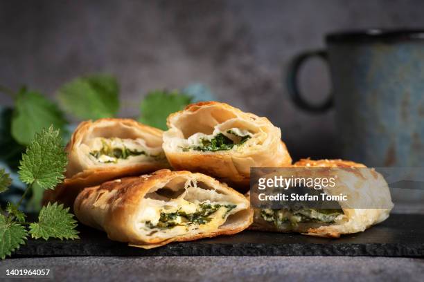 greek spanakopita pie with nettles - spinach pie stock pictures, royalty-free photos & images