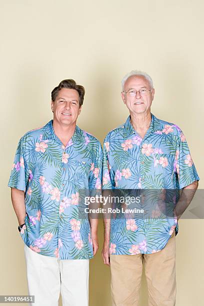 portrait of senior man with adult son wearing hawaiian shirts - hawaiian shirt imagens e fotografias de stock