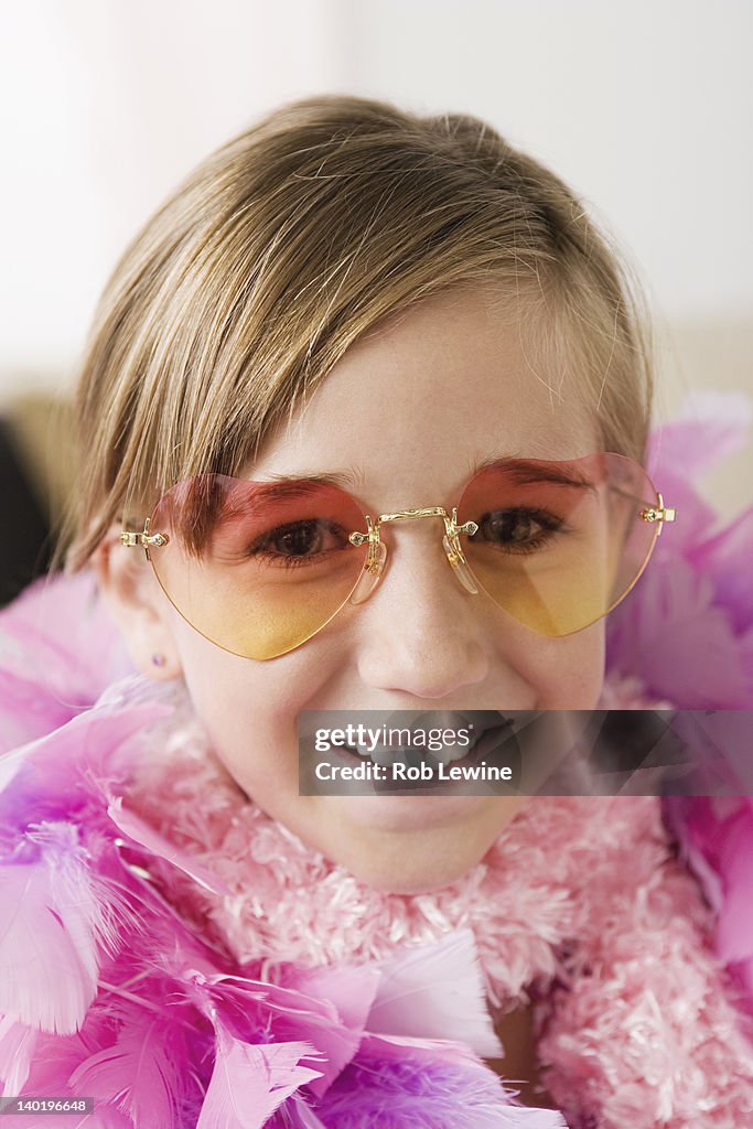 USA, California, Los Angeles, Portrait of smiling girl (10-11) wearing feather boa and sunglasses
