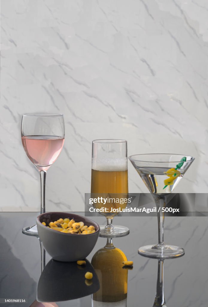 Close-up of drinks on table against wall