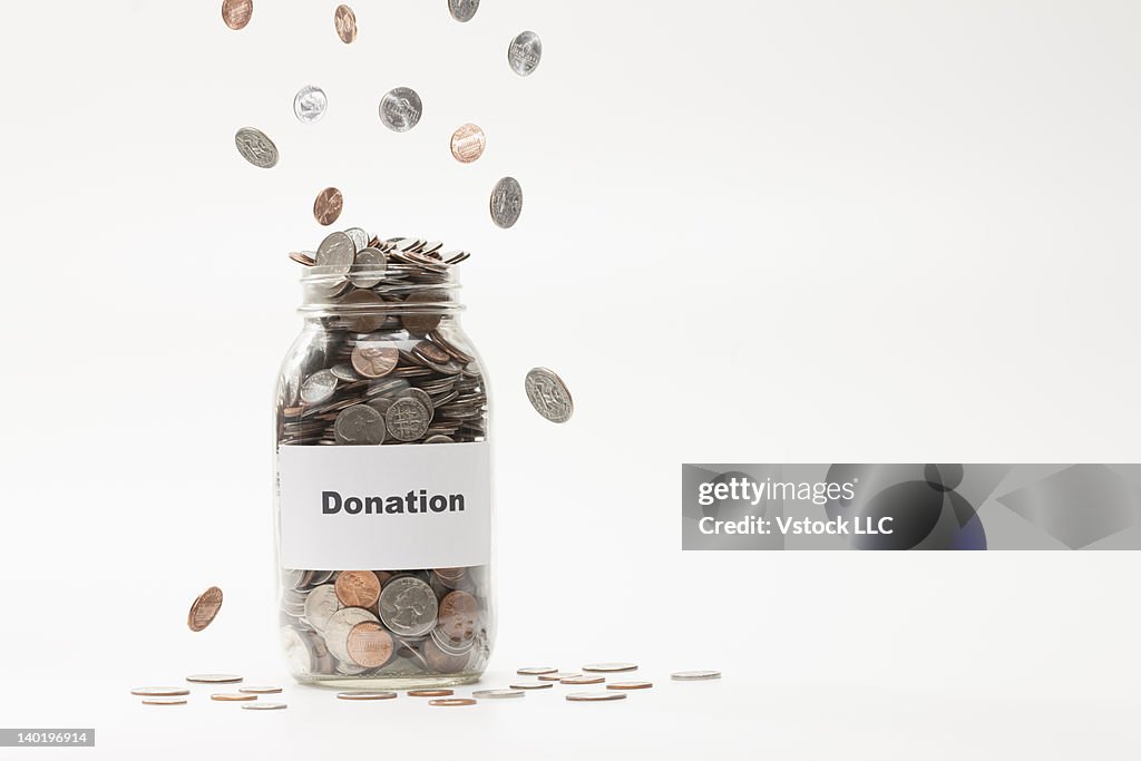 Studio shot of jar full of coins