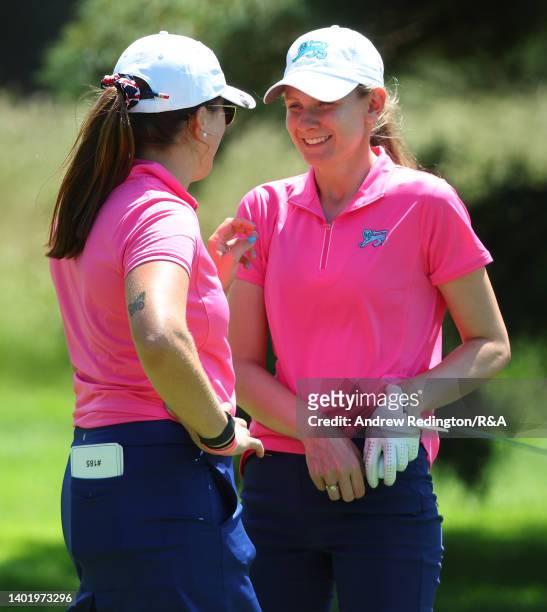 Amelia Williamson and Emily Price of Team Great Britain and Ireland share a joke during a practice round ahead of The Curtis Cup at Merion Golf Club...