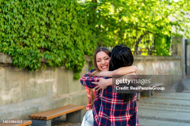 two best friends are hugging on the street - hello 2021 stock pictures, royalty-free photos & images