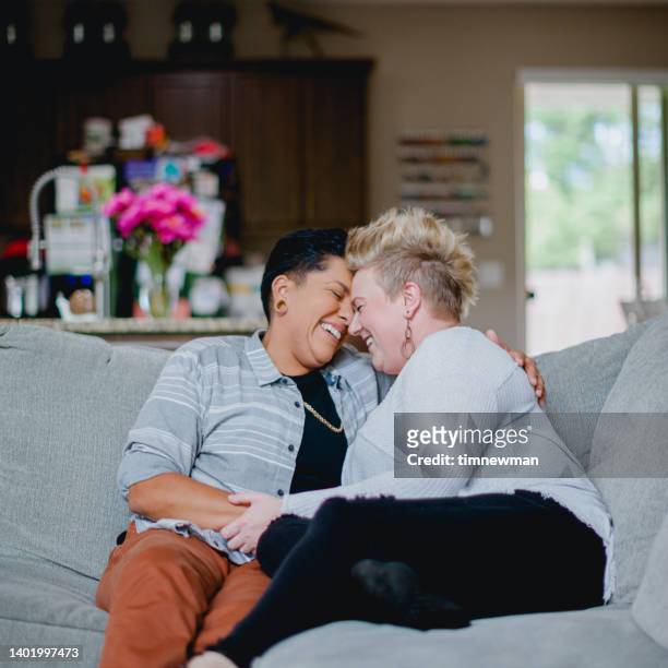 lesbian couple in love in their home - gay couple in love stock pictures, royalty-free photos & images