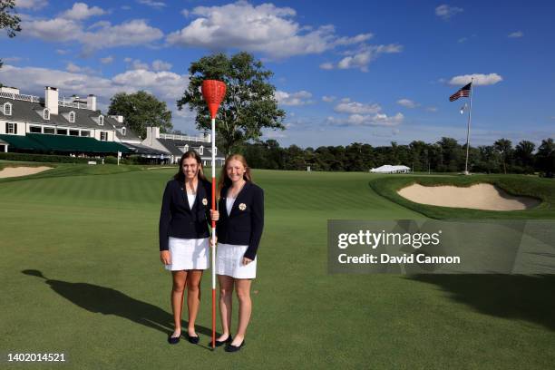 Hannah Darling and Louise Duncan of Scotland and The Great Britain and Ireland Team pose together with one of the unique Merion Golf Club 'Wicker...