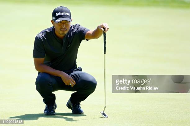 Satoshi Kodaira of Japan lines up a putt on the 13th green during the first round of the RBC Canadian Open at St. George's Golf and Country Club on...