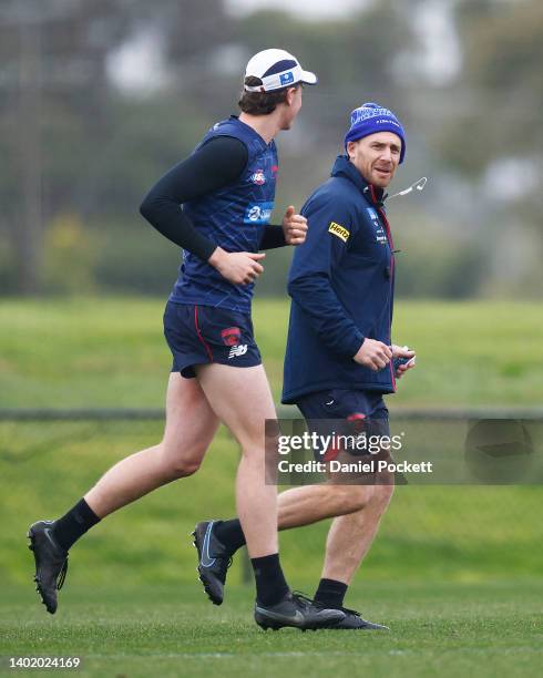 Demons head coach Simon Goodwin congratulates Daniel Turner of the Demons after announcing Turner will debut in Round 13 during a Melbourne Demons...