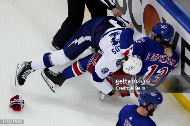 Steven Stamkos of the Tampa Bay Lightning fights with Alexis Lafrenière of the New York Rangers at the end of the third period in Game Five of the...