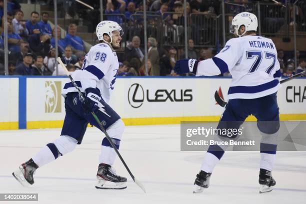 Mikhail Sergachev of the Tampa Bay Lightning celebrates with Victor Hedman after shooting the go-ahead goal against the New York Rangers during the...