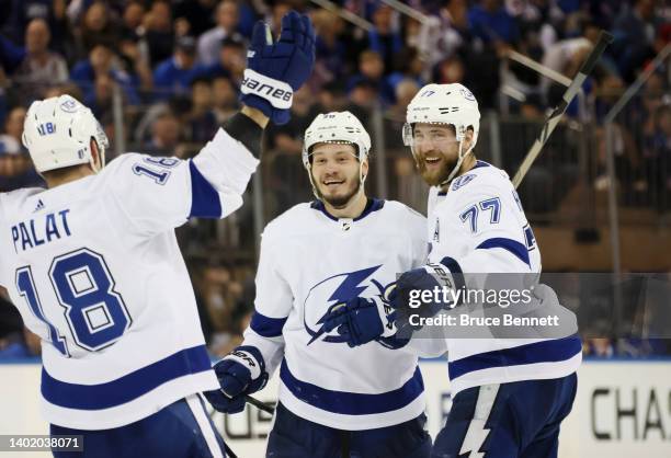 Mikhail Sergachev of the Tampa Bay Lightning celebrates with teammates after shooting the go-ahead goal against the New York Rangers during the third...