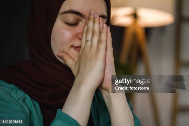 hoping the prayer carries her problems away - burka stock pictures, royalty-free photos & images