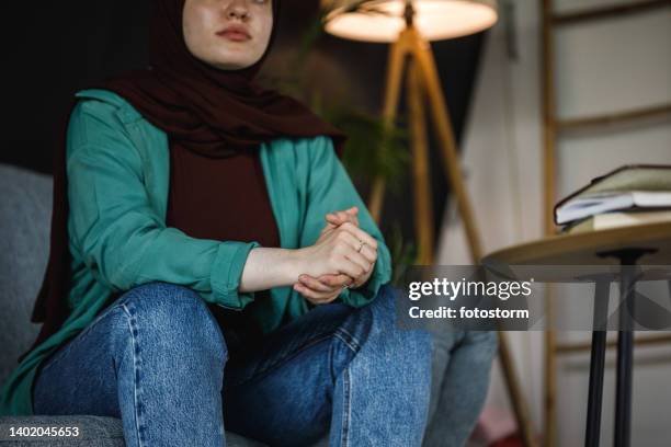 copy space shot of young woman cracking her knuckles while worrying and contemplating - burka stock pictures, royalty-free photos & images
