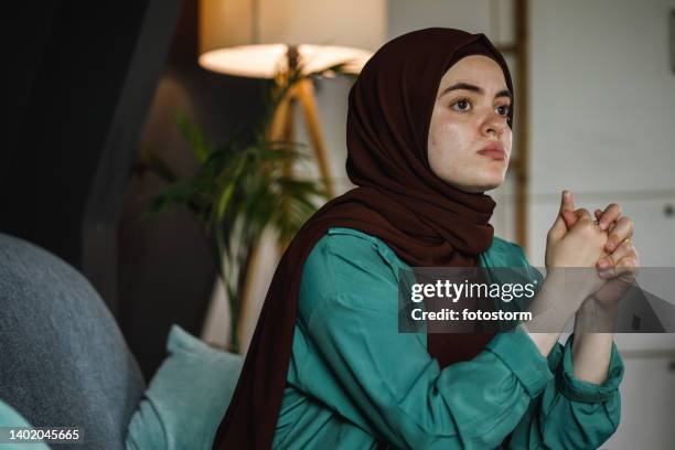 young woman stressing out and cracking her knuckles while worrying - burka stock pictures, royalty-free photos & images