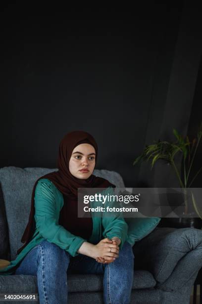 worried young woman contemplating solutions to her problems - burka stock pictures, royalty-free photos & images