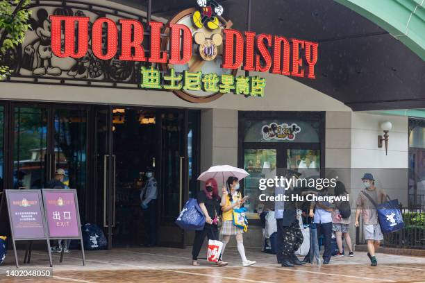 Visitors patronize a store at Shanghai Disney Resort on June 10, 2022 in Shanghai, China. Shanghai Disney Resort is resuming partial operations, with...
