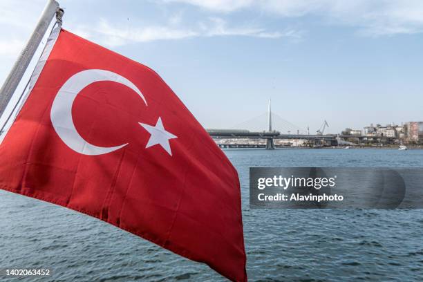 turkish flag on boat on bosphorus river moving in the wind - símbolo stock pictures, royalty-free photos & images
