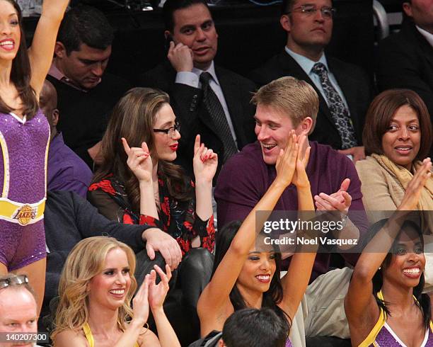 Emmy Rossum and Tyler Jacob Moore attend a basketball game between the Minnesota Timberwolves and the Los Angeles Lakers at Staples Center on...