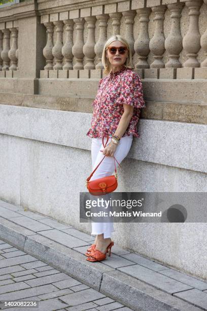 Petra Dieners, Fashion Influencer, is seen wearing Horror Vacui München blouse, white Mother Denim jeans, orange Bottega Veneta shoes, Dior handbag...