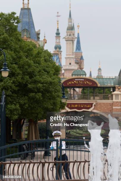Resort staff shuts a gate at a closed section of Disneyland at Shanghai Disney Resort on June 10, 2022 in Shanghai, China. Shanghai Disney Resort is...
