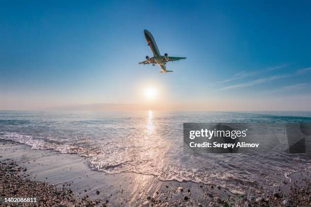 airplane heading towards airport nearby sea coastline - beach plane stock pictures, royalty-free photos & images