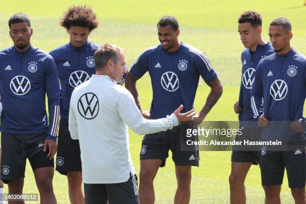 Head coach Hans-Dieter Flick talks to his players during a training session of the German national soccer team at Adi-Dassler-Stadion of adidas Herzo...