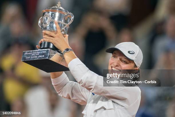 Iga Swiatek of Poland with the winners trophy after her victory against Coco Gauff of the United States during the Singles Final for Women on Court...