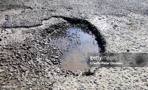 Pothole filled with water in a road on June 10,2022 in London, England.