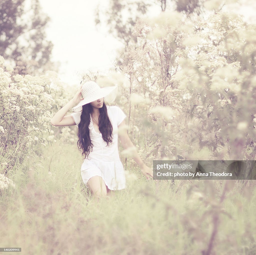 Portrait of young woman in high grass