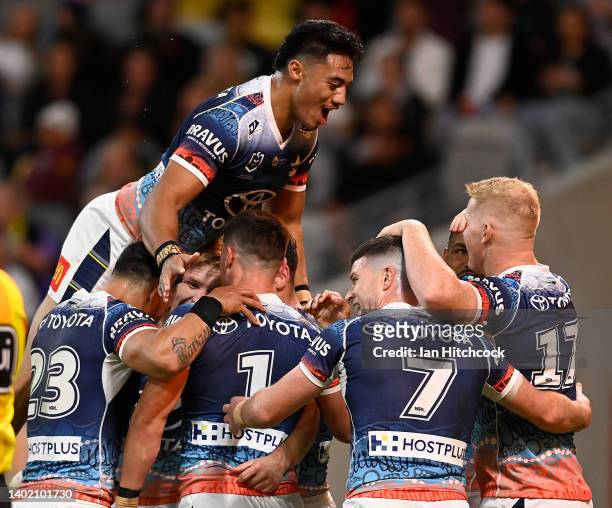 Reece Robson of the Cowboys celebrates after scoring a try during the round 14 NRL match between the North Queensland Cowboys and the St George...