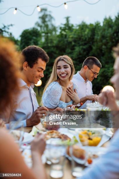 foto grandangolare di persone che cenano all'aperto in estate. grande gruppo di amici e familiari che mangiano in un bel giardino - pranzare allaperto foto e immagini stock