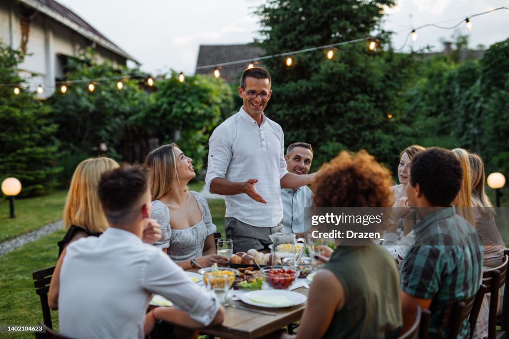 Having Man Having Speech During Outdoor Dinner With Friends And Family High ...