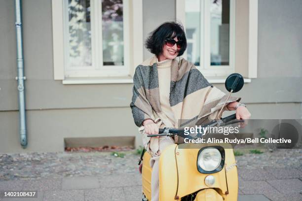 senior woman on a motor scooter - riding vespa stock pictures, royalty-free photos & images