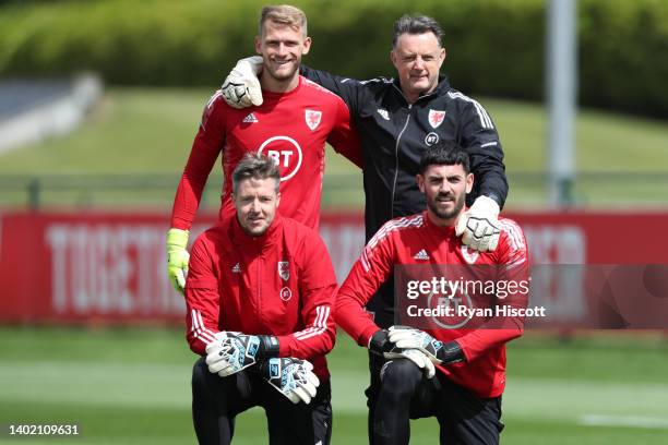 Adam Davies of Wales, Tony Roberts, Wales goalkeeping coach, Wayne Hennessey of Wales and Tom King of Wales pose for a photo during a training...