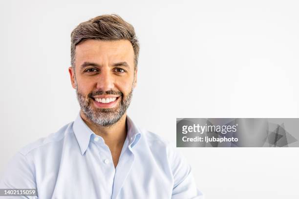 smiling mature man on white background - smiling mature eyes stockfoto's en -beelden