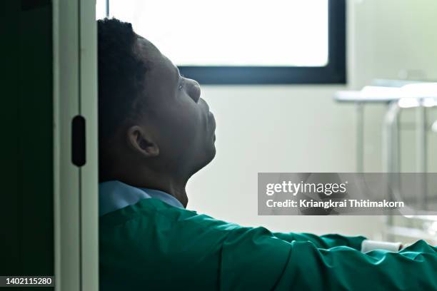 a medical doctor is being tired after long working day. - hospital quarantine stock pictures, royalty-free photos & images