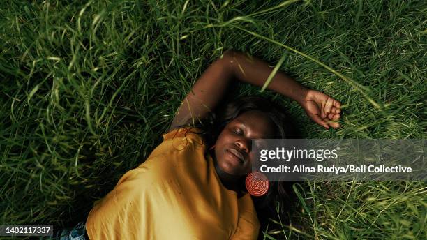 woman daydreaming on a meadow - sognare ad occhi aperti foto e immagini stock