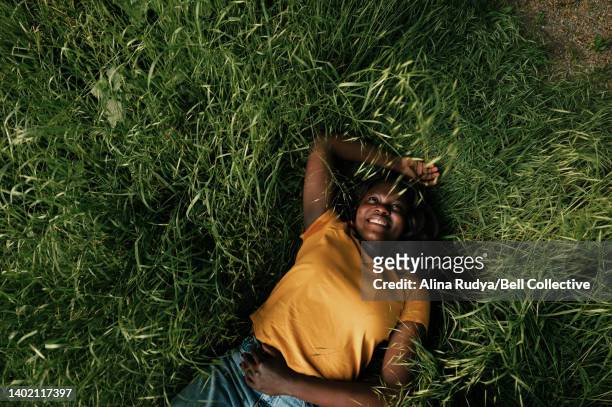 woman daydreaming on a meadow - showus - fotografias e filmes do acervo